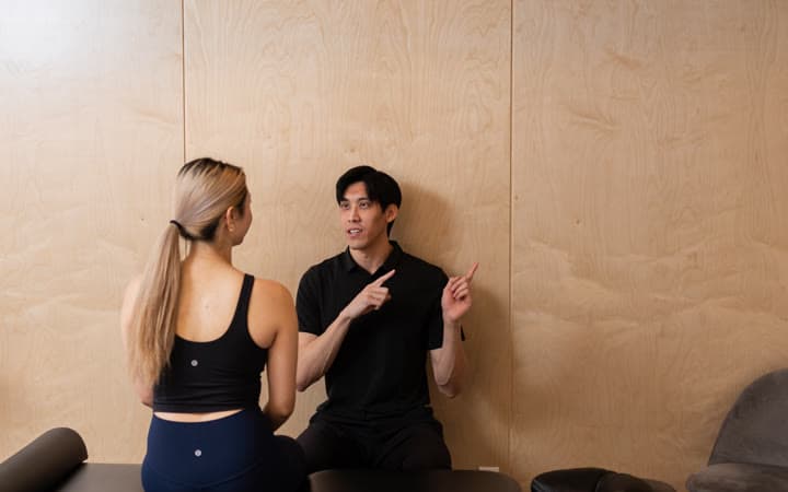 A therapist coaching guided movement to keep pain from returning